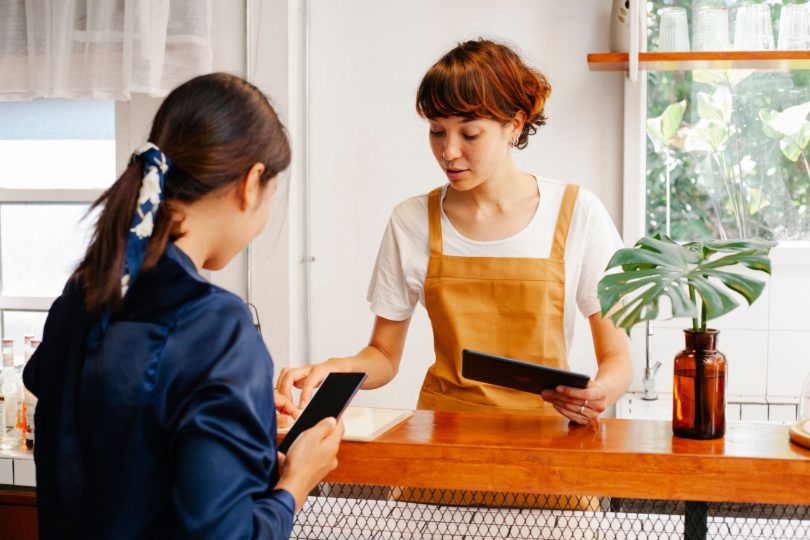 Pessoa usando smartphone para deixar avaliação de negócio local